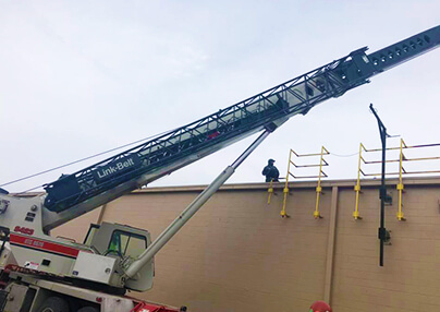 Commercial job being accomplished with a crane.
